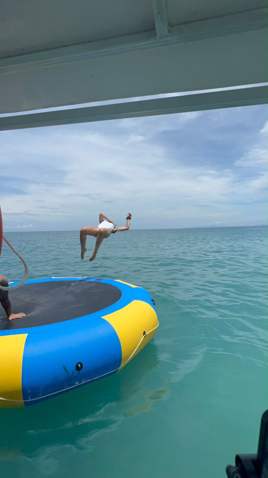 Guest flipping off the floating water trampoline into the ocean